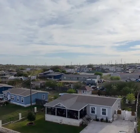an aerial view of house with yard lake and city view