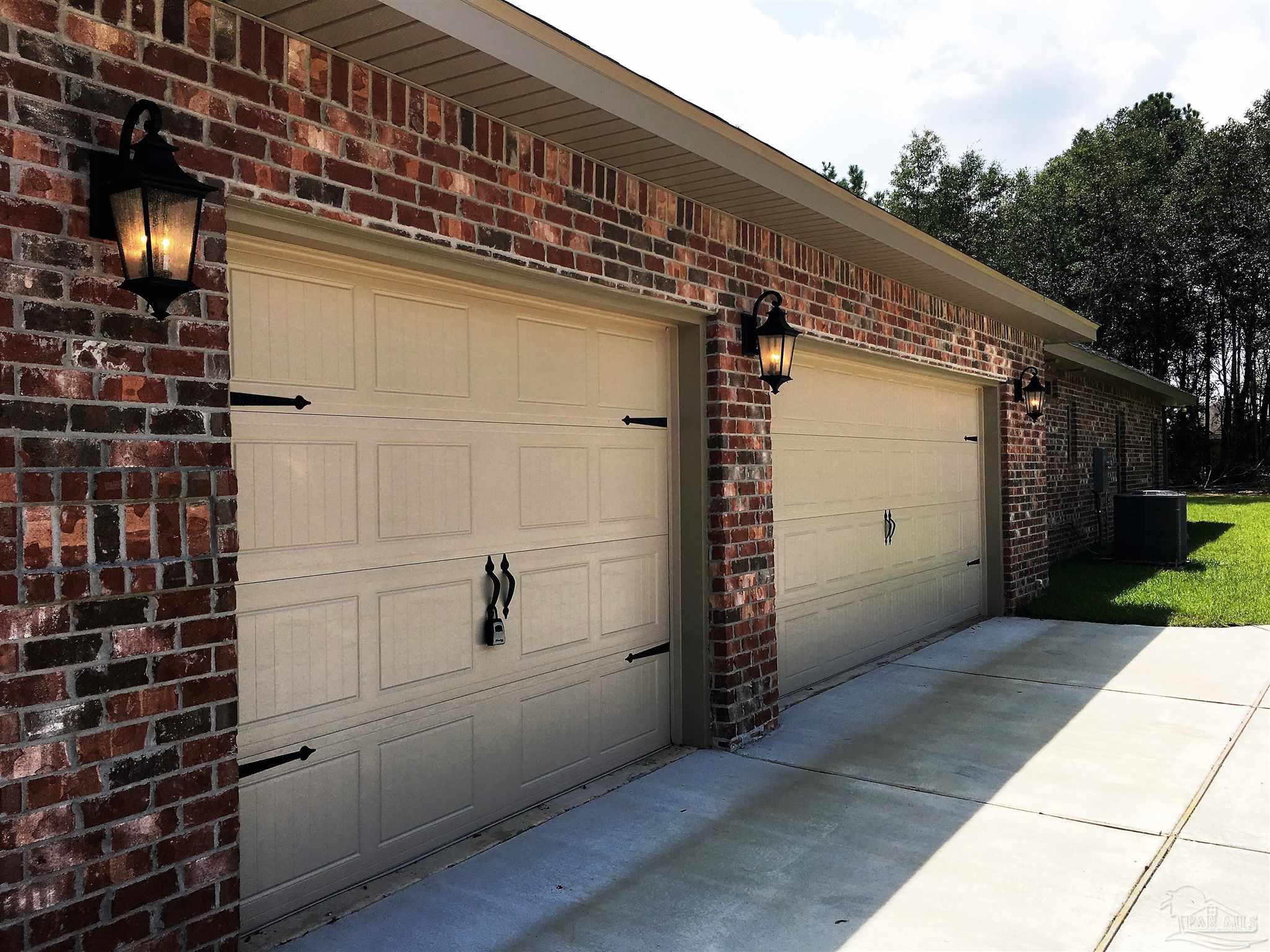 5210 South A Jones Road Milton, FL 32583 - Photo 2 of 37 3-car side entry garage exterior is shown here.