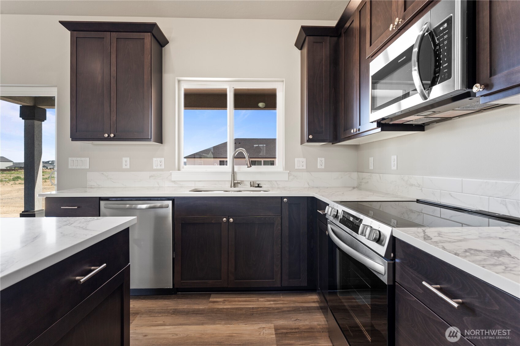 713 O Street Southwest Quincy, WA 98848 - Photo 13 of 34 a kitchen with stainless steel appliances granite countertop a sink stove and cabinets