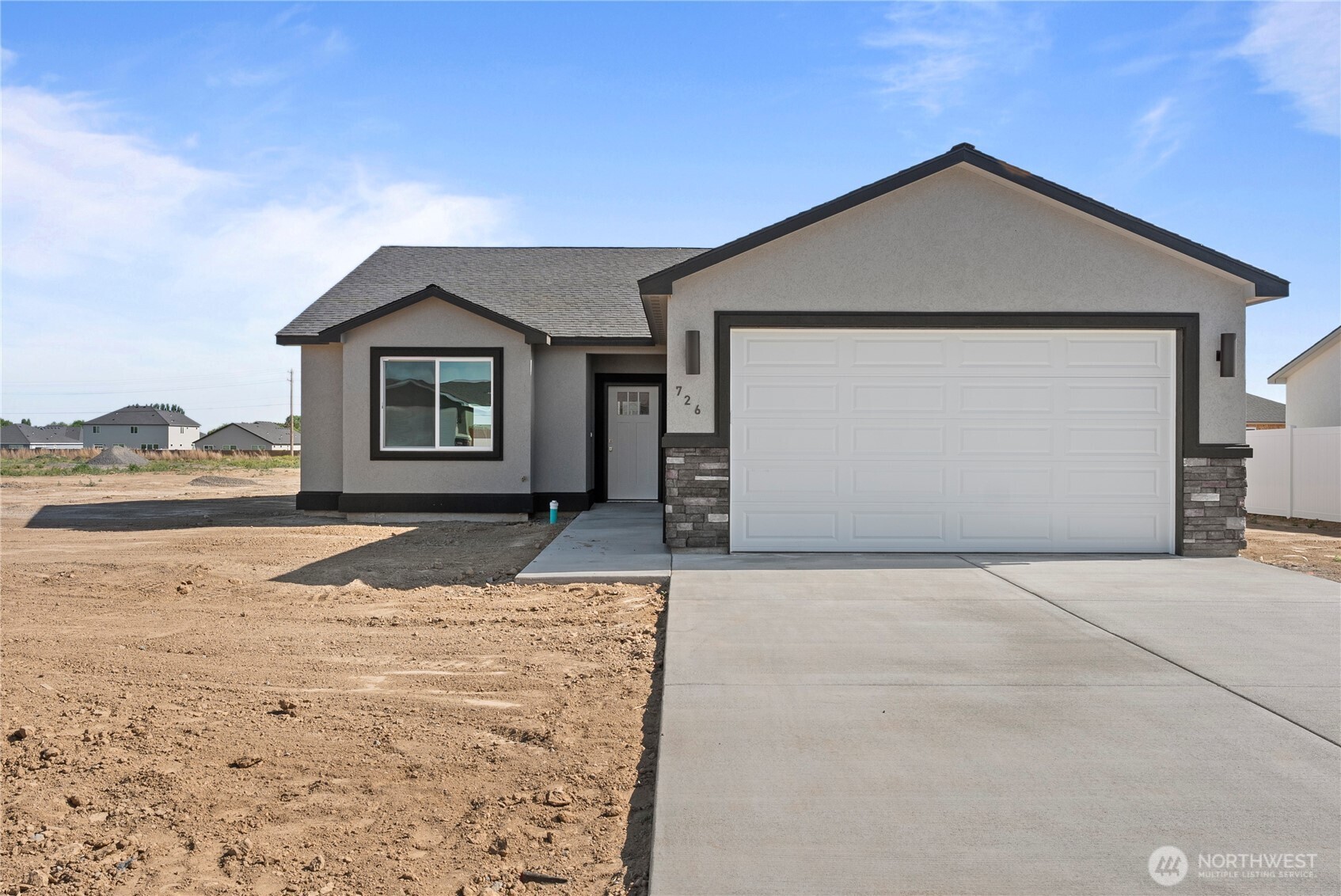 713 O Street Southwest Quincy, WA 98848 - Photo 2 of 34 a front view of a house with a yard and garage
