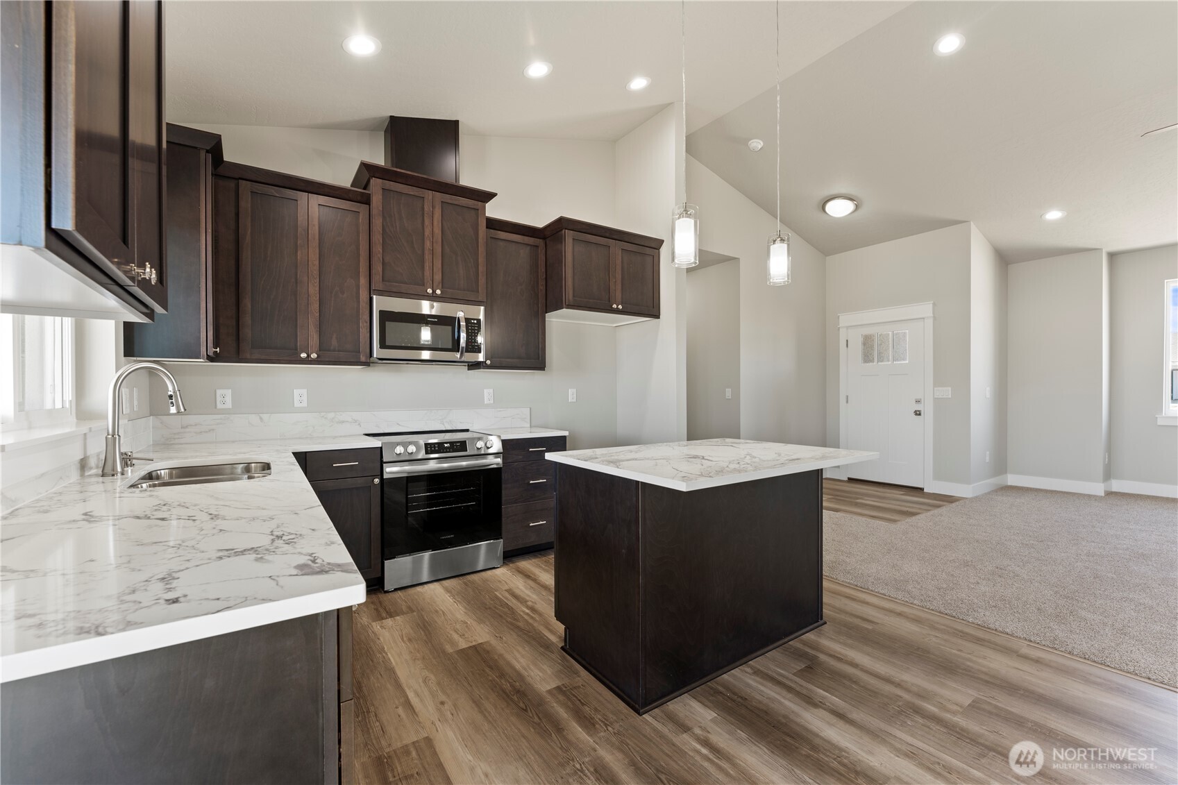 713 O Street Southwest Quincy, WA 98848 - Photo 4 of 34 a kitchen with stainless steel appliances granite countertop a stove a sink and a refrigerator