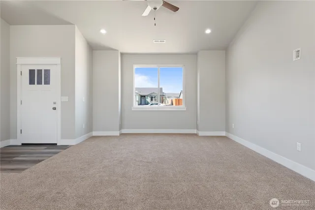 an empty room with windows and closet