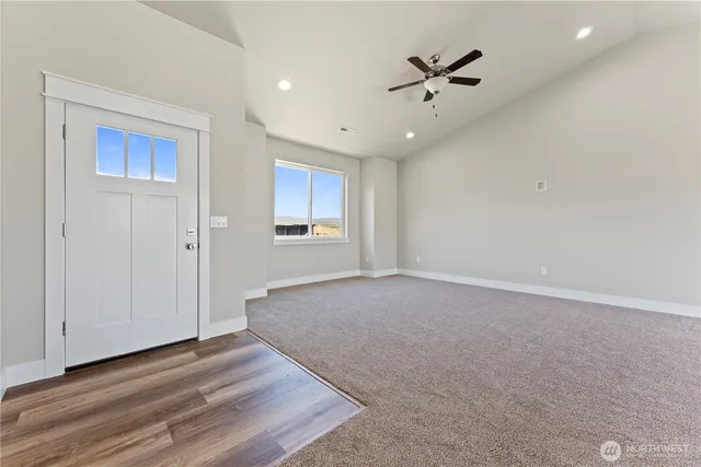a view of an empty room with a ceiling fan