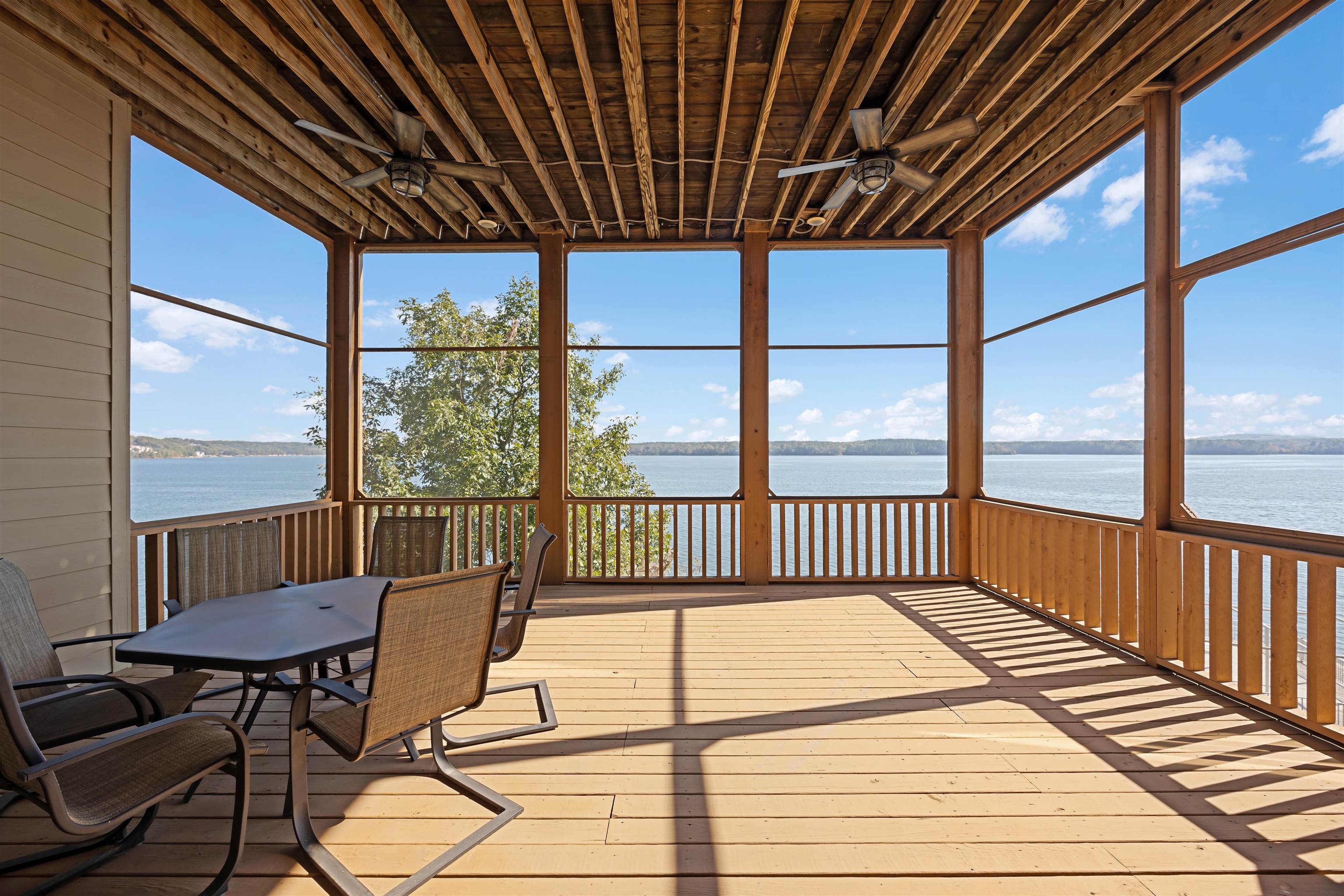 45 Pinnacle Pointe Savannah, TN 38372 - Photo 23 of 30 Screen porch with ceiling fan, a water view, and outdoor dining space