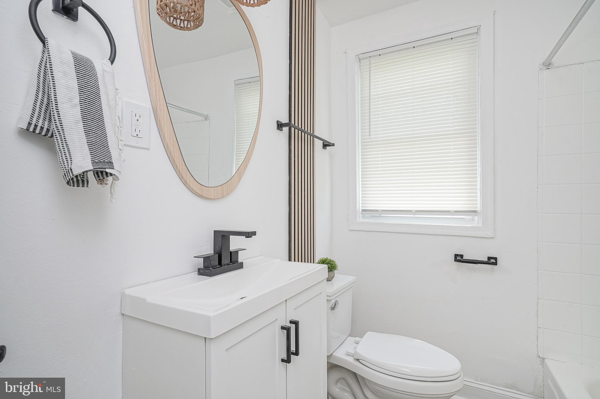 133 Lemmon Avenue Pemberton, NJ 08068 - Photo 13 of 25 a bathroom with a sink a toilet and a mirror