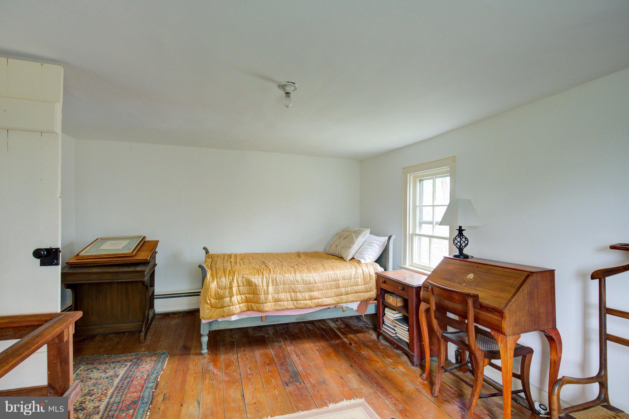 18812 Harmony Church Road Leesburg, VA 20175 - Photo 18 of 30 a bedroom with a bed and wooden floor