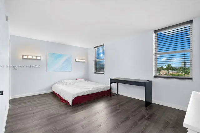 a spacious bedroom with a bed and a table in it