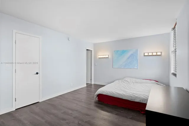 a bedroom with a bed and a night stand