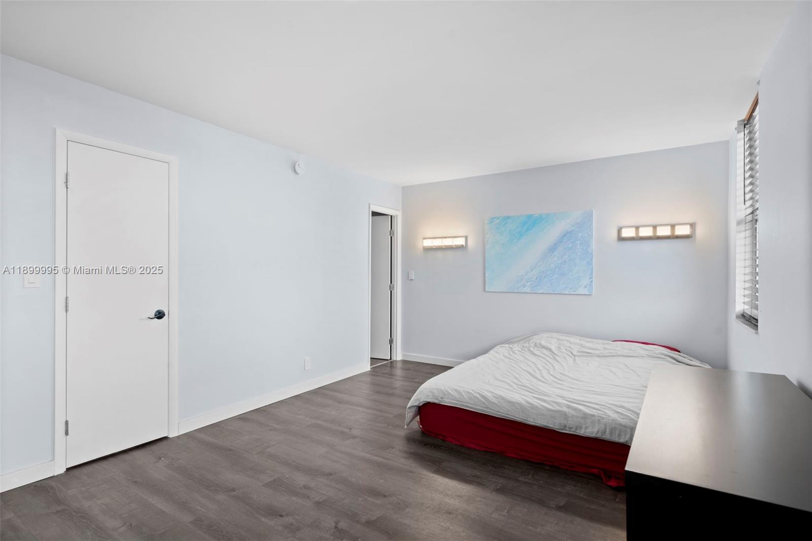 437 Golden Isles Drive, Unit 5J Hallandale Beach, FL 33009 - Photo 13 of 34 a bedroom with a bed and a night stand