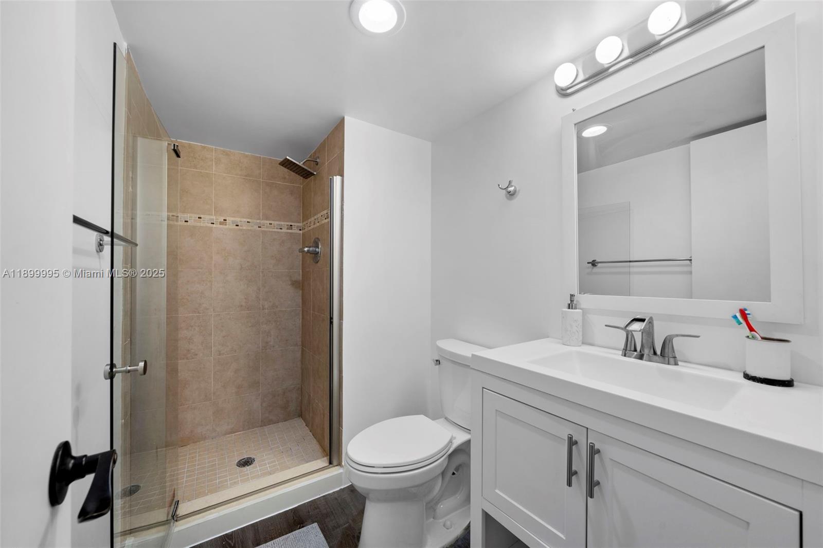 437 Golden Isles Drive, Unit 5J Hallandale Beach, FL 33009 - Photo 20 of 34 a bathroom with a sink toilet and shower