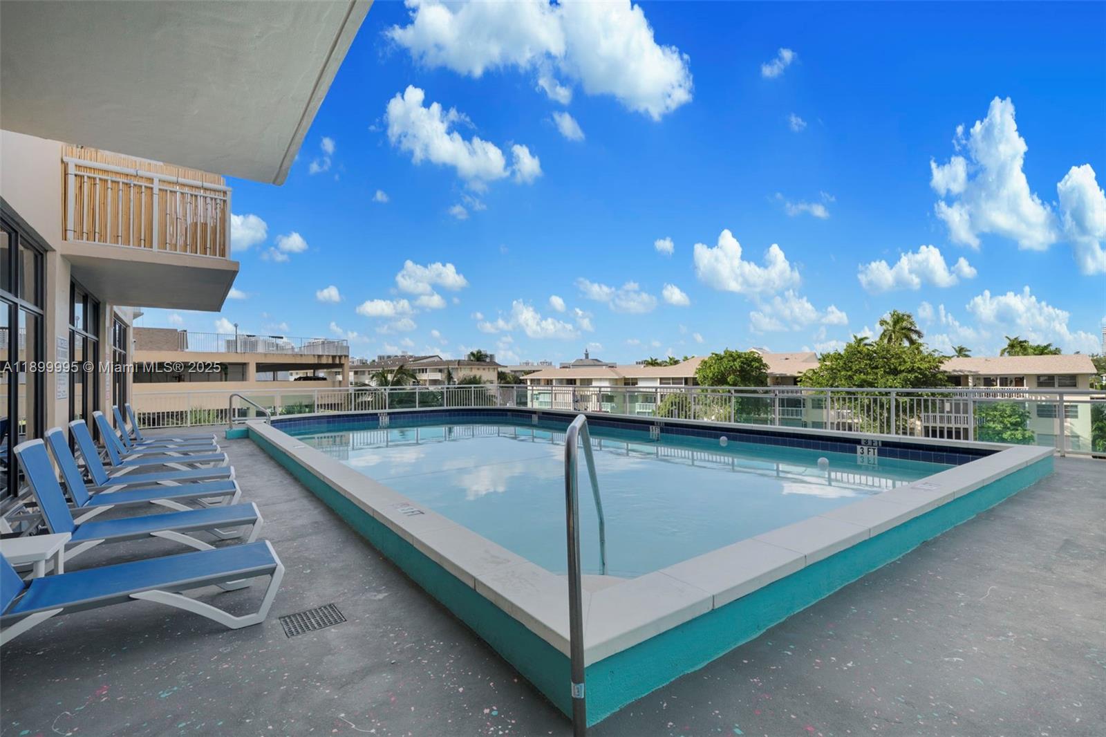 437 Golden Isles Drive, Unit 5J Hallandale Beach, FL 33009 - Photo 23 of 34 a view of a swimming pool with outdoor seating