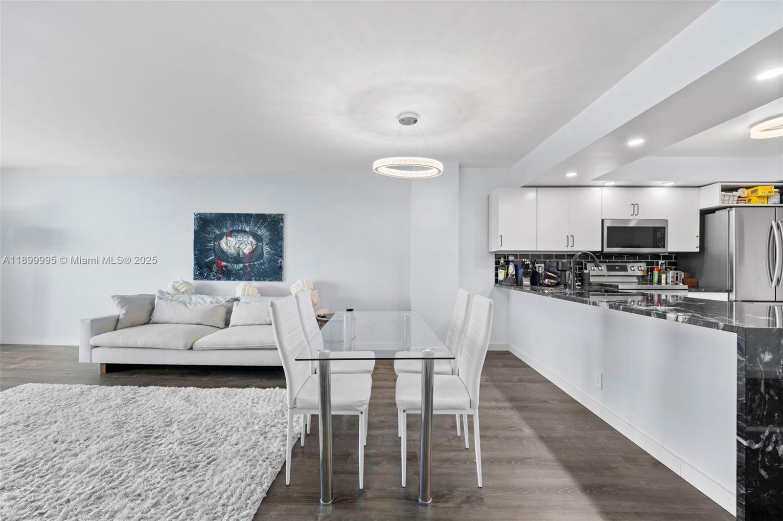 437 Golden Isles Drive, Unit 5J Hallandale Beach, FL 33009 - Photo 5 of 34 a living room with stainless steel appliances furniture and a kitchen view