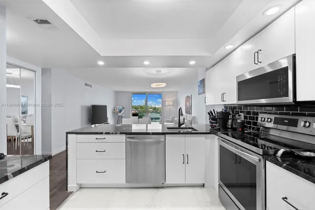 a kitchen with a sink stove top oven and microwave