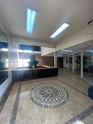 a view of a hallway with furniture