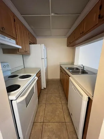 a kitchen with a stove and a refrigerator