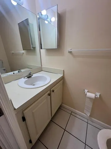 a bathroom with a sink a vanity and mirror