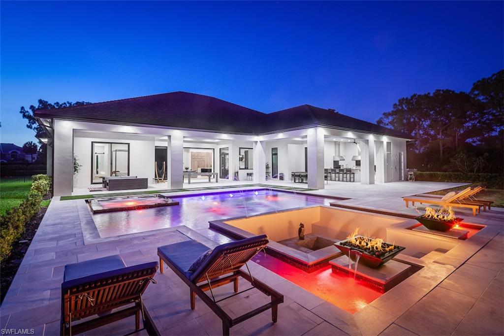 a view of swimming pool with chairs and tables