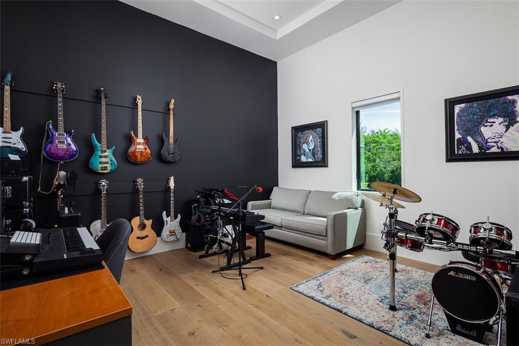 728 Carica Road Naples, FL 34108 - Photo 12 of 26 a living room with furniture a rug and a chandelier