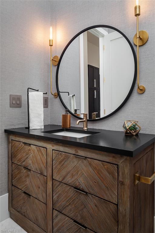 728 Carica Road Naples, FL 34108 - Photo 17 of 26 a bathroom with a sink and a mirror