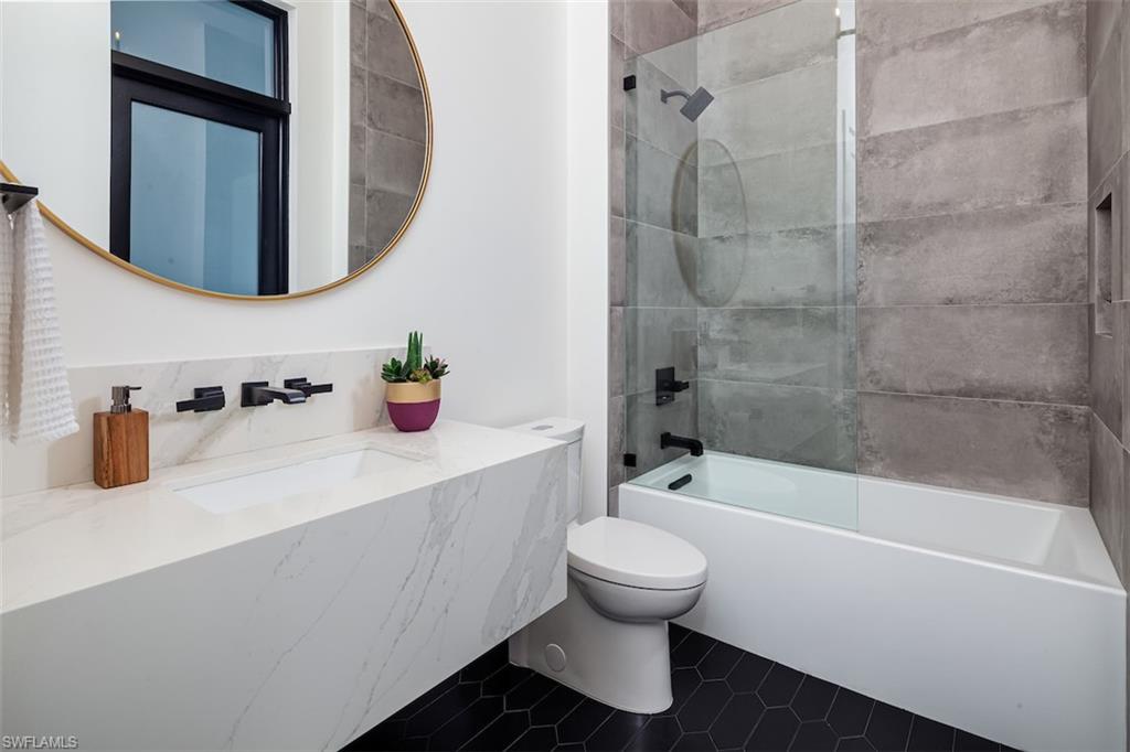 728 Carica Road Naples, FL 34108 - Photo 18 of 26 a bathroom with a sink toilet and shower