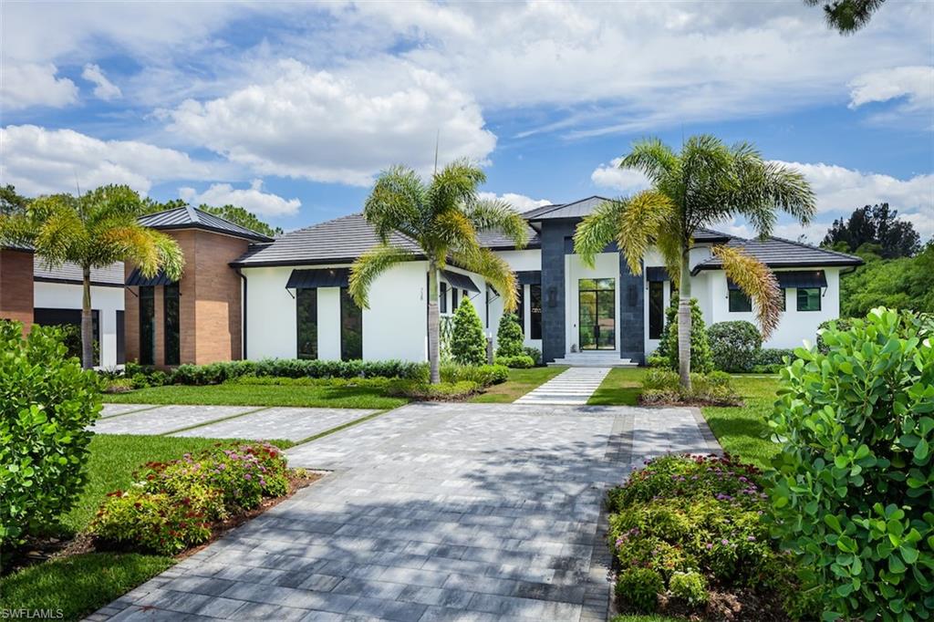 728 Carica Road Naples, FL 34108 - Photo 20 of 26 a front view of a house with garden