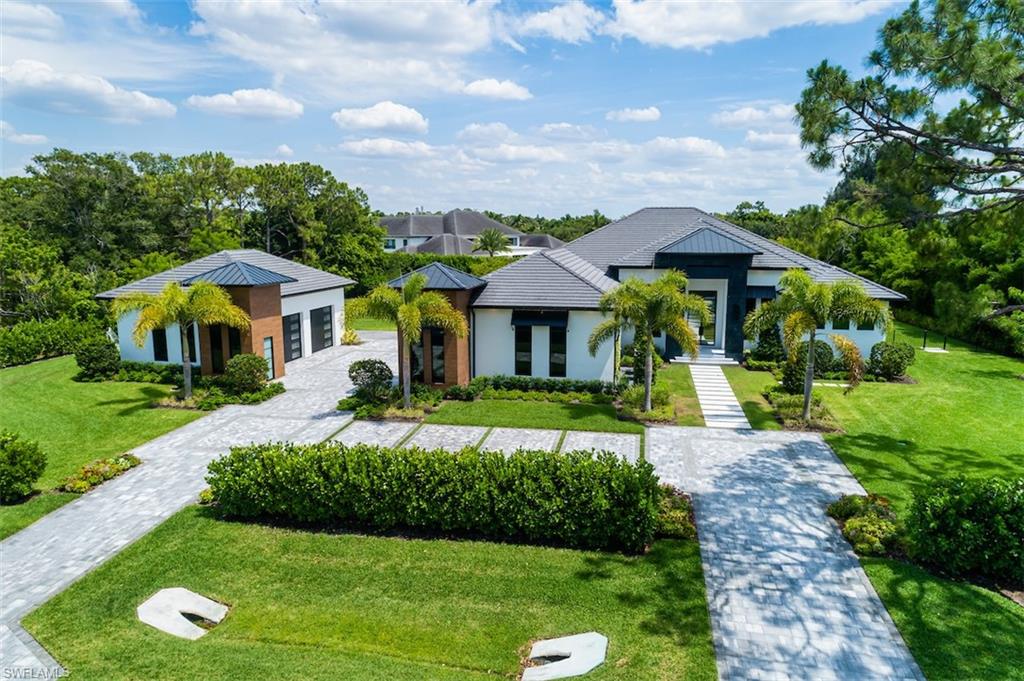 728 Carica Road Naples, FL 34108 - Photo 22 of 26 a front view of a house with garden