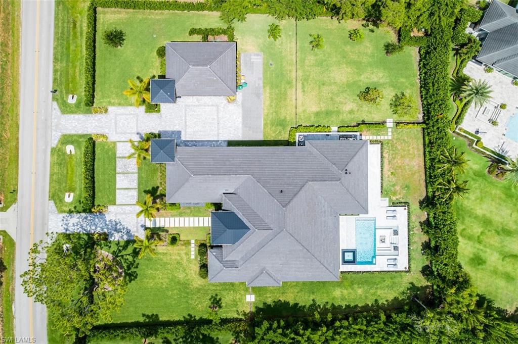 728 Carica Road Naples, FL 34108 - Photo 24 of 26 an aerial view of a house with a yard swimming pool and outdoor seating