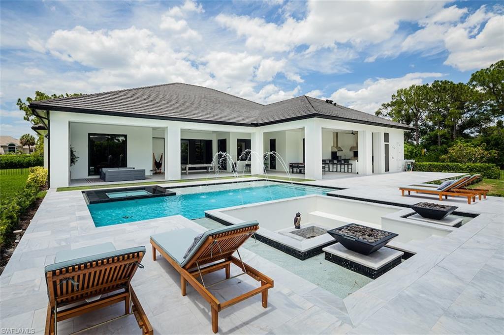 728 Carica Road Naples, FL 34108 - Photo 26 of 26 a front view of house with yard and outdoor seating