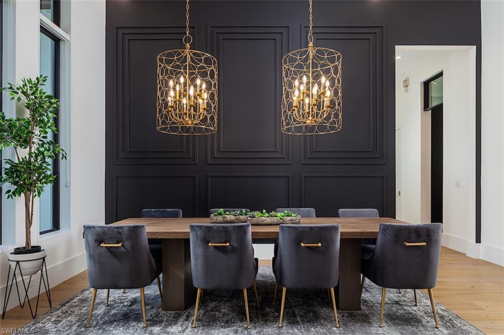 728 Carica Road Naples, FL 34108 - Photo 5 of 26 a dining room with furniture a chandelier and window