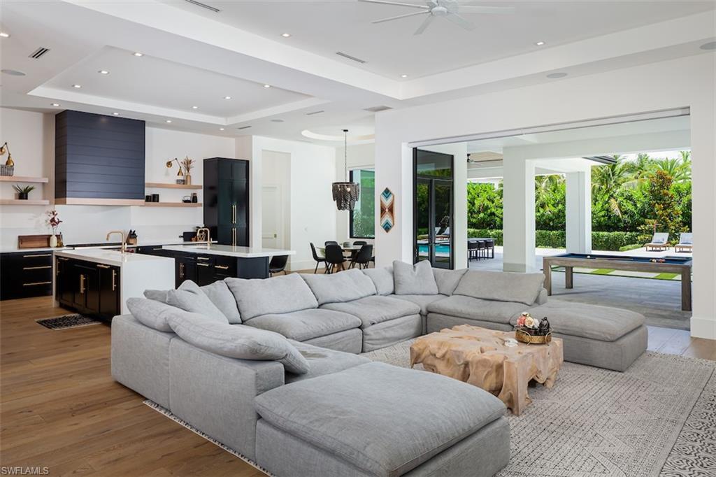 728 Carica Road Naples, FL 34108 - Photo 8 of 26 a living room with furniture and a large window