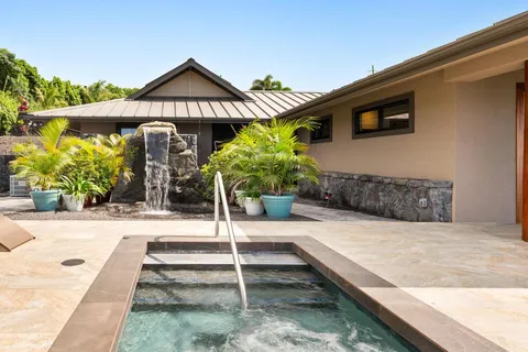 a swimming pool with potted plants