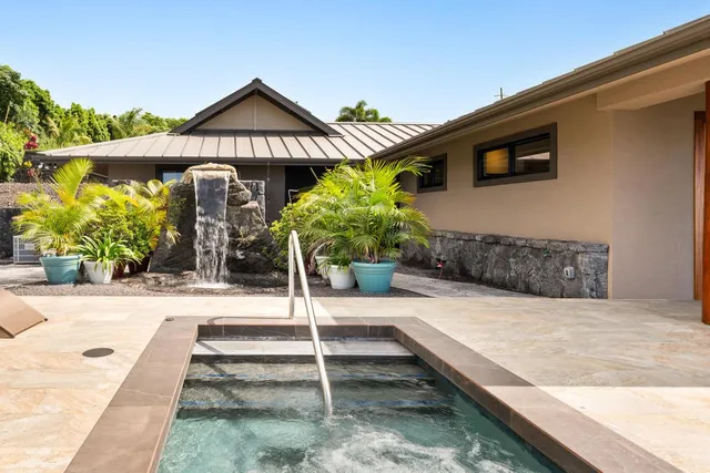 a swimming pool with potted plants