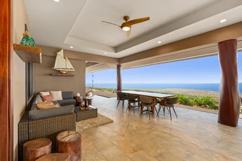 a dining room with furniture and a floor to ceiling window