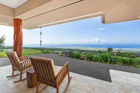 a view of a patio with lawn chairs floor to ceiling window and yard