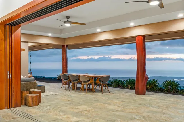 a dining room with furniture and a garden view