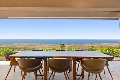 a view of chairs and table in the ocean