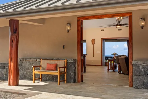 a view of a hallway with wooden floor and furniture