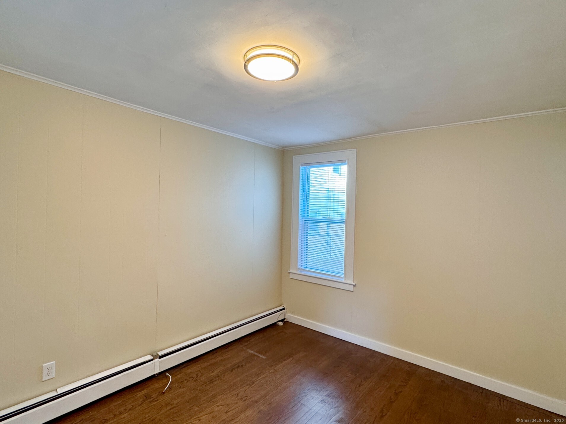 132 North Elm Street, Unit U1 Torrington, CT 06790 - Photo 7 of 12 an empty room with wooden floor and windows