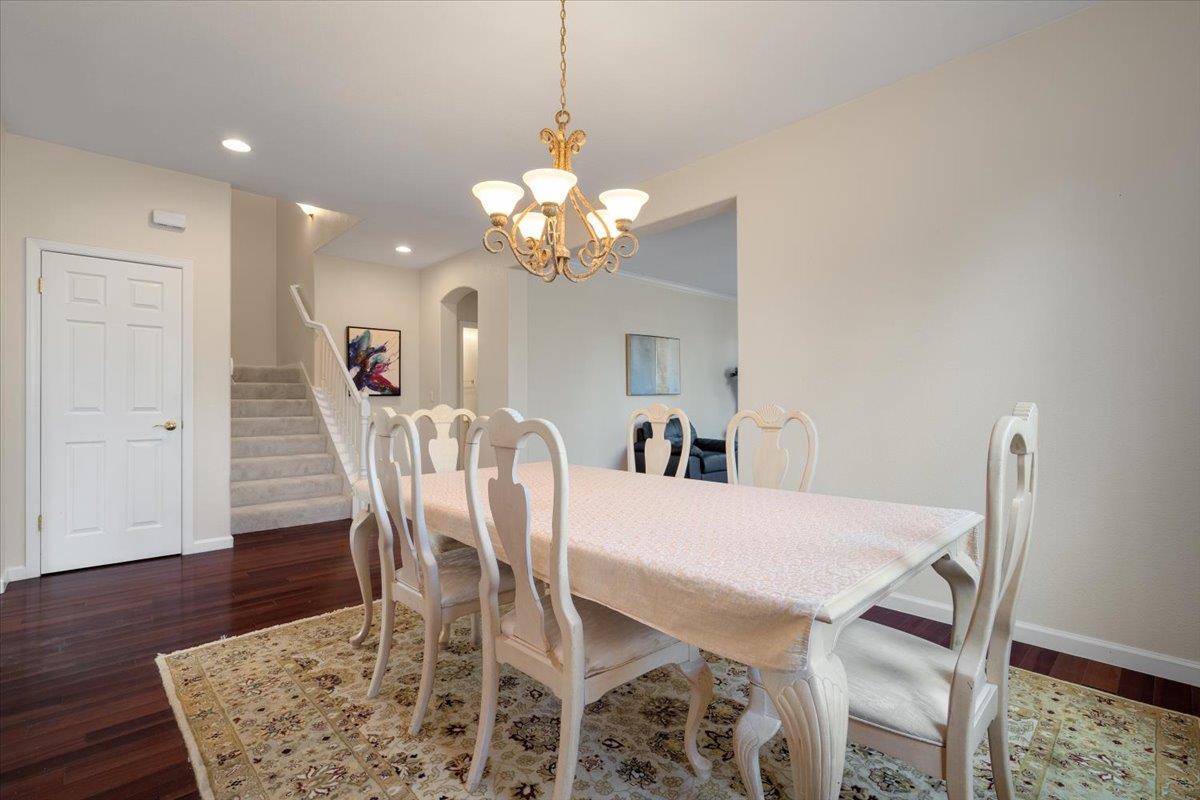 9145 Desiderio Way Gilroy, CA 95020 - Photo 12 of 33 a view of a dining room with furniture and wooden floor