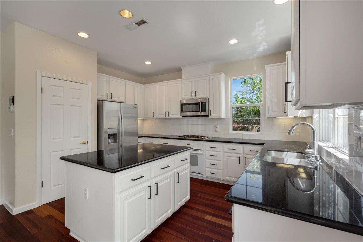 9145 Desiderio Way Gilroy, CA 95020 - Photo 13 of 33 a kitchen with stainless steel appliances granite countertop a sink a stove and refrigerator