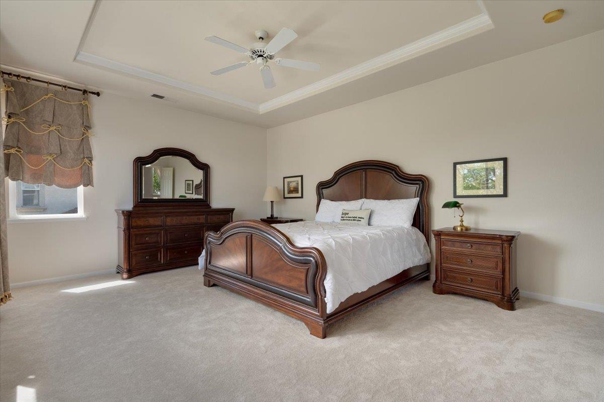 9145 Desiderio Way Gilroy, CA 95020 - Photo 19 of 33 a bedroom with a bed lamp and dresser