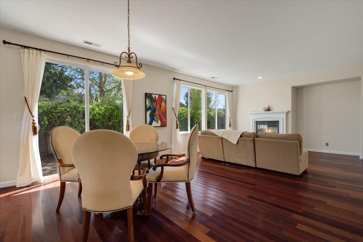 9145 Desiderio Way Gilroy, CA 95020 - Photo 8 of 33 a dining room with furniture a chandelier and wooden floor