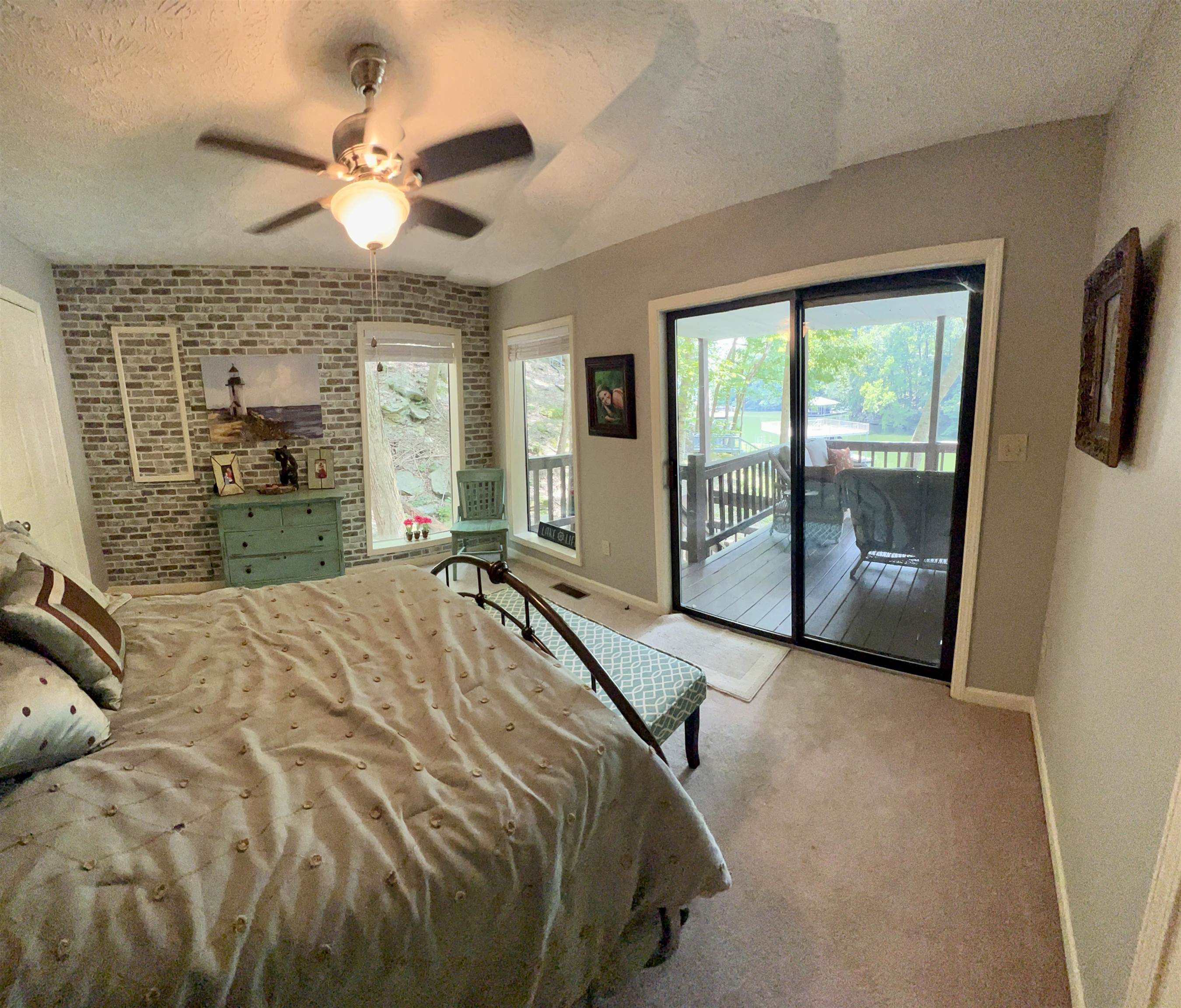 60 Point Grand Bluff Savannah, TN 38372 - Photo 19 of 34 a bed sitting in a spacious bedroom next to a window