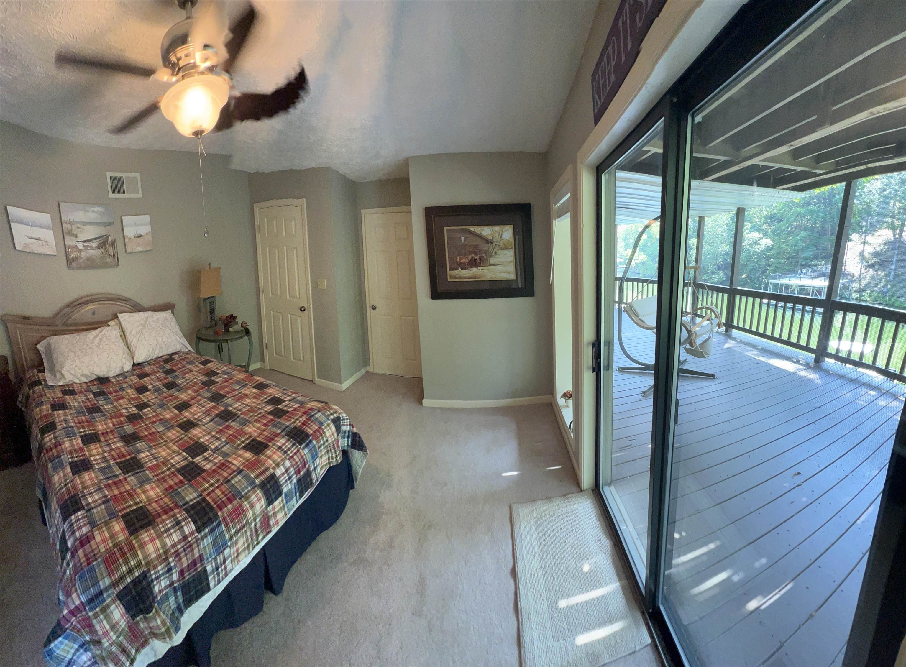 60 Point Grand Bluff Savannah, TN 38372 - Photo 20 of 34 a bedroom with a bed and a large window with wooden floor