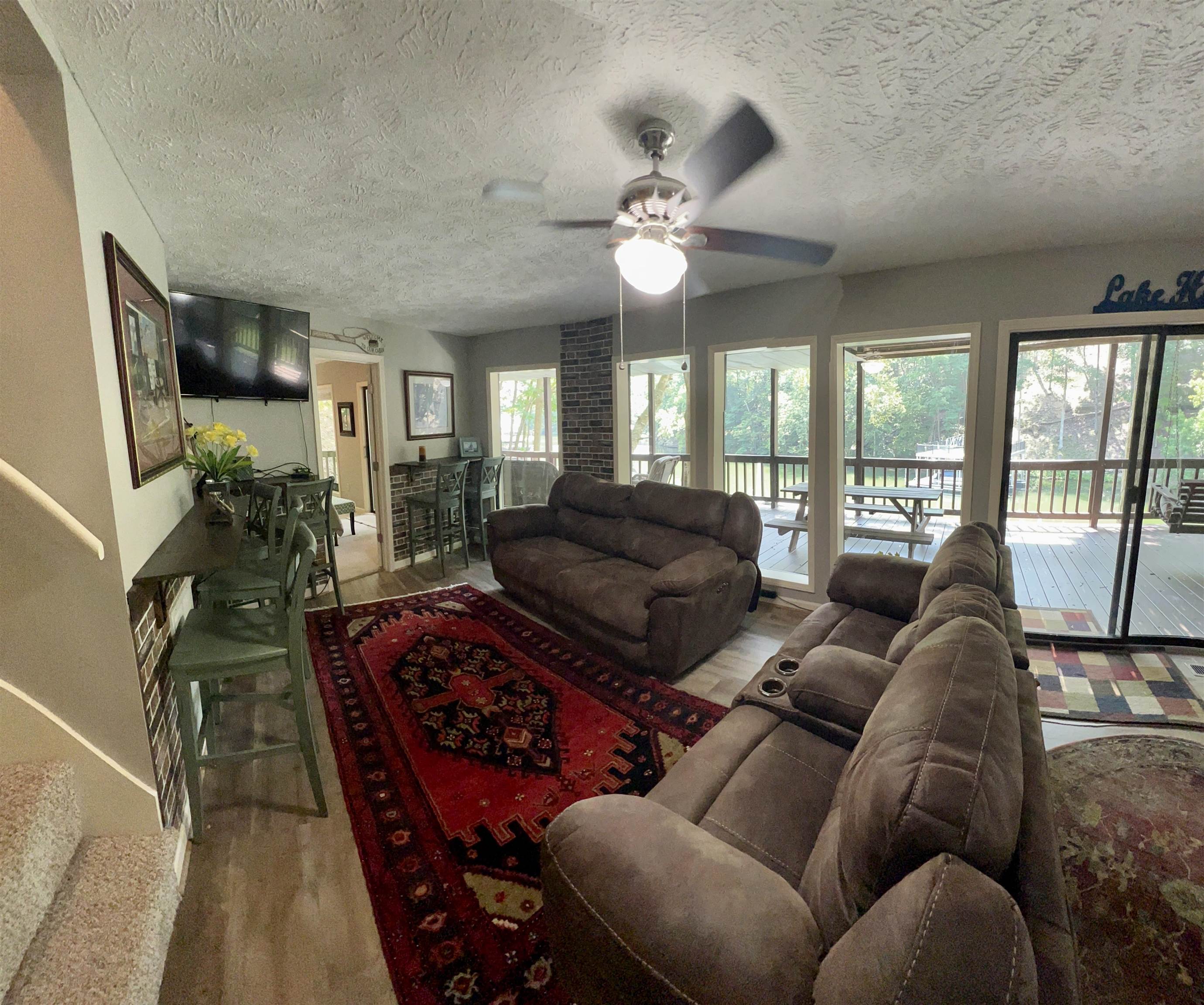 60 Point Grand Bluff Savannah, TN 38372 - Photo 22 of 34 a living room with furniture a flat screen tv and a large window