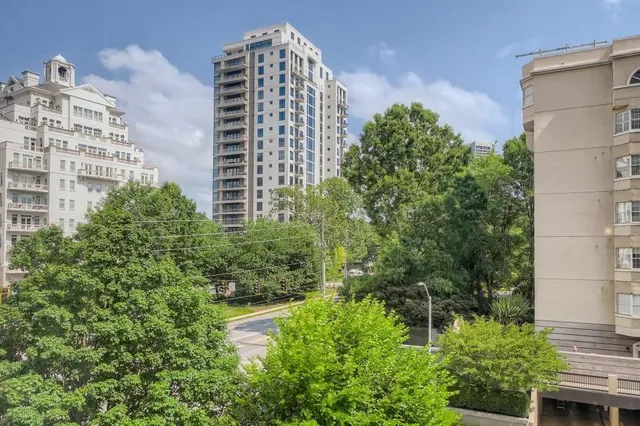 a view of a tall building next to a yard
