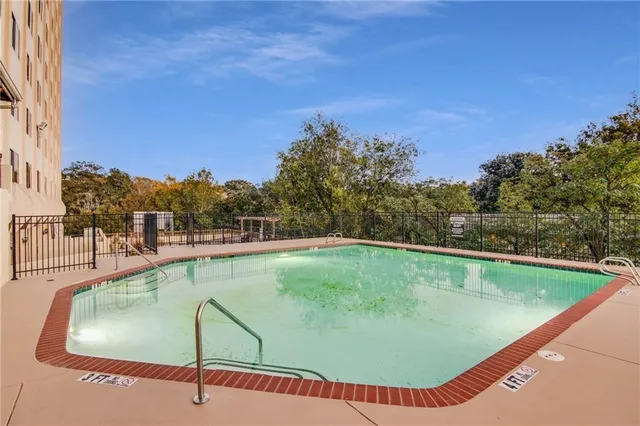 a view of a swimming pool with a yard