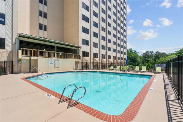 a view of a roof deck with table and chairs