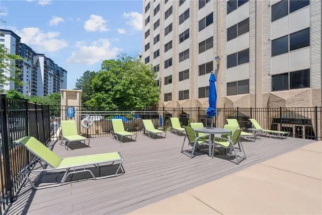 a view of swimming pool with outdoor seating and plants