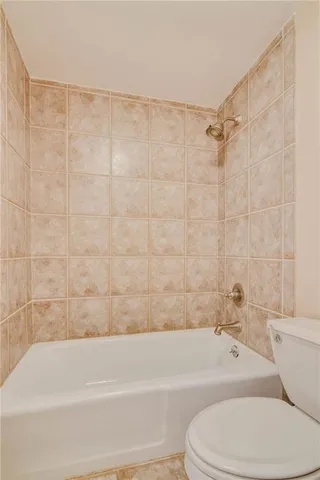 a bathroom with a toilet bathtub and shower